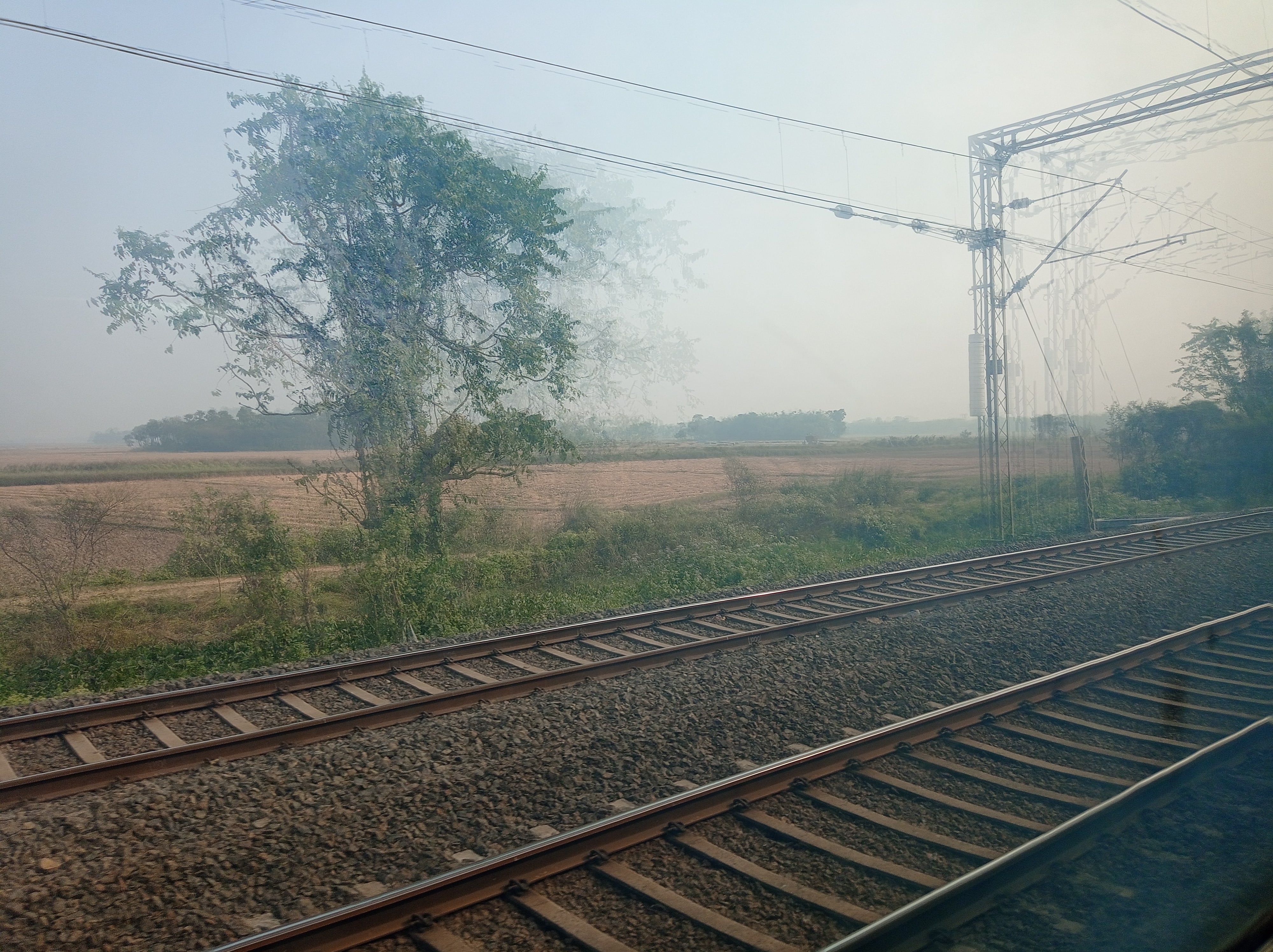 Slanting sunrays on a lazy smoggy landscape